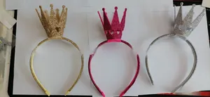 Detailed view of glitter crown headbands in gold, pink, and silver with heart cutouts