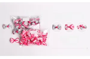 Detail view of 20 pieces fabric bow hair clips featuring pink stripes and floral patterns