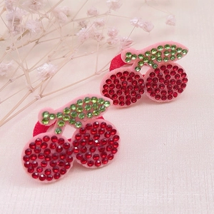 Close-up of sparkling red rhinestone cherry hair ties with high-elastic rubber bands
