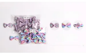 Detail view of 20-piece sets of floral and rainbow bow hair clips for baby girls