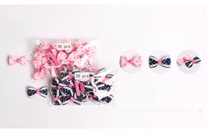 Detail view of 20-piece sets of polka dot bow hair clips with lace trim for babies