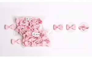 Detail showing 20 pieces of pink striped bow hair clips in clear packaging for kids