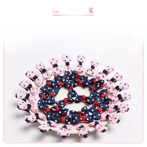 Detail view of 40-piece bow hair clip set with pink and navy polka dot patterns