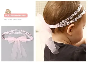 Détail d'un bandeau bébé en dentelle rose avec nœud en maille, perles et strass