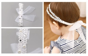 Détail d'un bandeau en dentelle pour bébé avec broderie florale fine, perles et strass