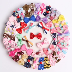 Set of colorful bow hair clips for girls with polka dots and floral patterns in a white tray