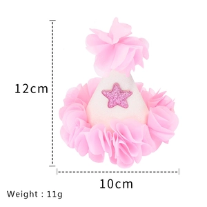 Pink birthday party hat with tulle flowers and size dimensions shown on white background