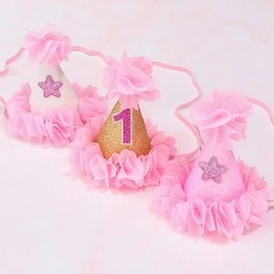 Close-up of birthday party hats with glitter number one and sparkling stars set