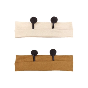 Cute knitted baby headbands with black pom-pom bee antennae in cream and brown set