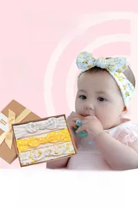 Detail view of 3-piece baby headband gift set with hand-made bows in a window box