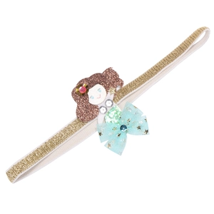 Close-up of golden glitter headband with mermaid sequin detail and blue bow for girls