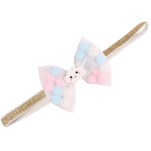 Detail of baby headband with golden glitter band and tulle bow filled with colorful pom-poms