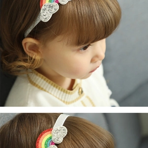 Detail view of infant rainbow unicorn headband with glitter cloud and silver elastic band