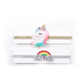 Detail of baby sequin headbands featuring colorful unicorn and rainbow decorations