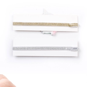 Detail view of gold and silver unicorn headbands set for babies on display card