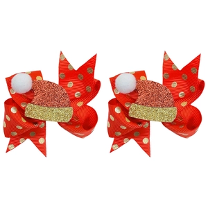 Dettaglio di fiocchi rossi per capelli con pois dorati e piccoli cappelli di Babbo Natale