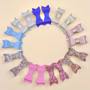 Litchi leather and glitter bow hair clips in assorted colors arranged in a circle