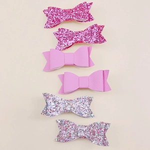 Detail of 6-piece handmade glitter and lychee leather bow hair clips set for girls