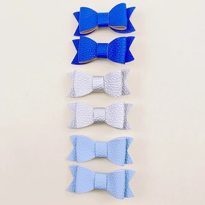 Detail of glitter leather hair clips with litchi texture in blue and silver colors