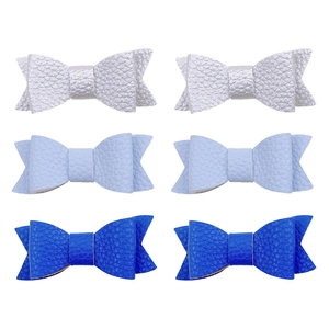Close-up of six-piece handmade lychee pattern faux leather bow hair clips in three colors
