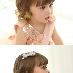 Detail of pink glitter bow hair clip on model with sparkling sequin dress