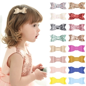 Toddler model wearing a glitter bow clip and set of 16 colorful hair accessories
