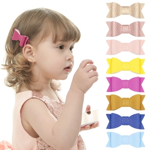 Detail view of lychee leather hair bow clips for kids in 8 vibrant glitter colors