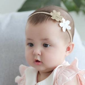 Elastic baby headband with delicate gold and white embroidered flowers for infants