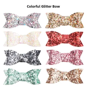 Detail view of chunky glitter bowknot hair clips in eight different sparkling colors