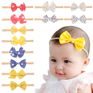 Detail of baby cotton linen bow headbands with elastic nylon bands in various colors