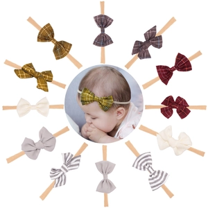 Set of 12 bow headbands for babies featuring patterns like plaid, stripes and solid colors