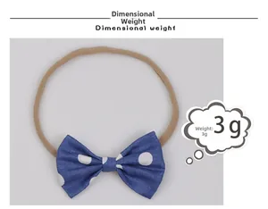 Detail view of blue polka dot baby bow headband with weight specification showing 3g