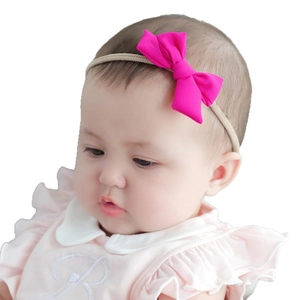 Sweet baby headband with a vibrant magenta bow on a soft elastic nylon band