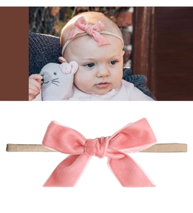 Detail of pink velvet bow headband for infants with a soft high-elastic beige band
