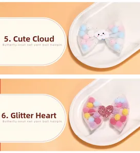 Detail view of butterfly net yarn hairpins with colorful pompons and cute cloud accents