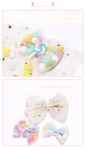 Close-up of mesh bow hair clip with colorful pom-poms and rainbow lollipop resin decor