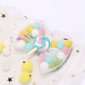White star mesh bow hair clip with colorful pom poms and a lollipop resin center