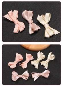 Close-up of pink polka dot and satin hair bows for kids with delicate ribbon textures