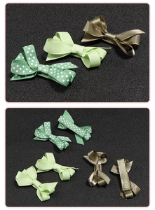 Detail of green grosgrain ribbon bow clips with polka dots and gold satin edges