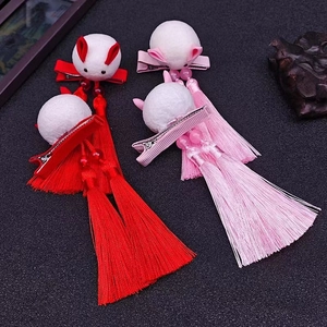 Detail of Chinese style rabbit hair clips with silk tassels and beads for traditional Hanfu
