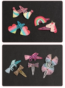 Detailansicht der glitzernden Haarklammern für Kinder mit Einhorn- und Regenbogenmotiven
