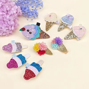 Flat lay di mollette per capelli glitterate a forma di gelato e fiori per bambine