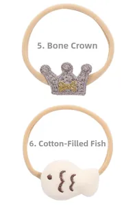 Detail of baby headband featuring crown crochet and stuffed plush fish decorative elements