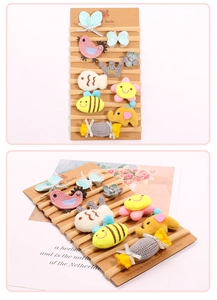 Close-up of 10-piece baby headband set with soft knit animals and floral charms