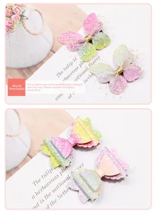 Detailed view of children's gradient glitter bow hair clips with pastel macaron sparkle finish