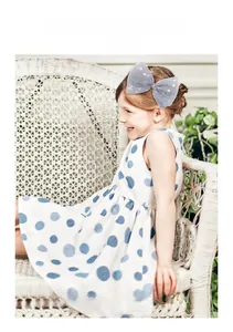 Toddler girl wearing a large lavender mesh bow hair clip with colorful polka dots