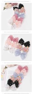 Detail of colorful polka dot tulle hair clips with star patterns for kids