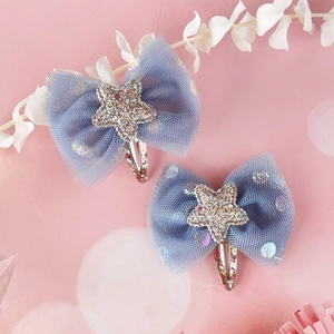 Detailed macro view of blue mesh bow hair clips with glitter star and sequin metallic base