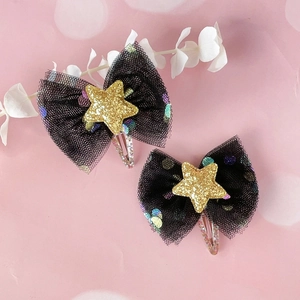 Close-up of kids mesh bow hair clips with gold stars and sparkling BB clips