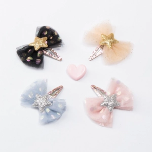 Set of four mesh bow hair clips with stars and polka dots in pastel colors
